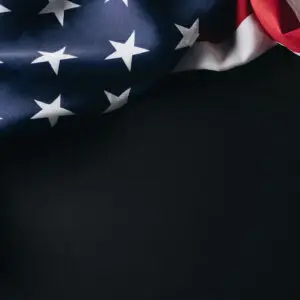 A folded American flag against a black background.